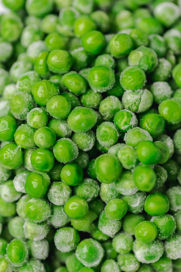 a close shot of frozen garden peas.