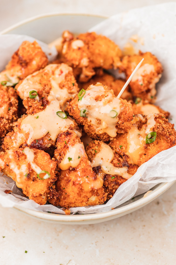 panko breaded chicken pieces covered with sauce.