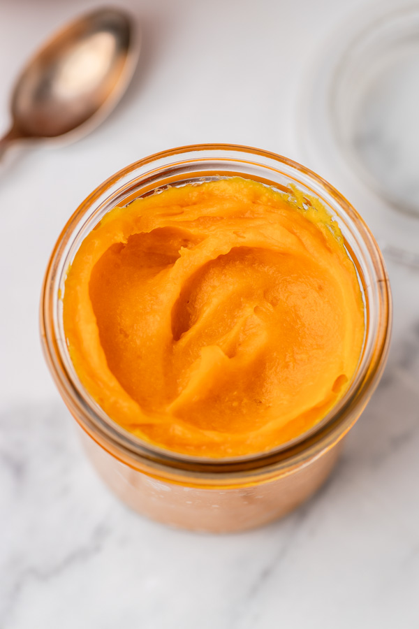 a jar of of cooked pumpkin puree.