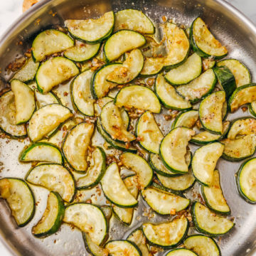 sauteed zucchi in a skillet.