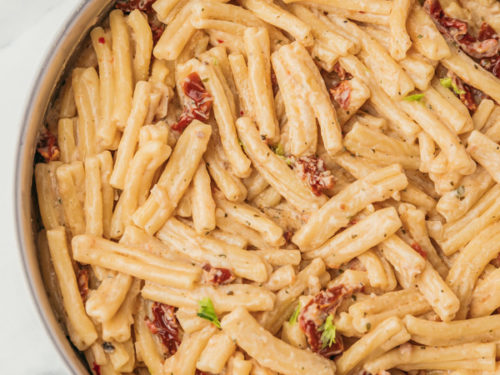 close up on cooked pasta in a skillet.