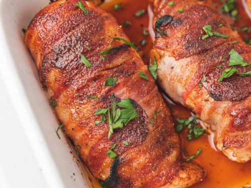 bacon wrapped chicken breast sitting in its own juice.