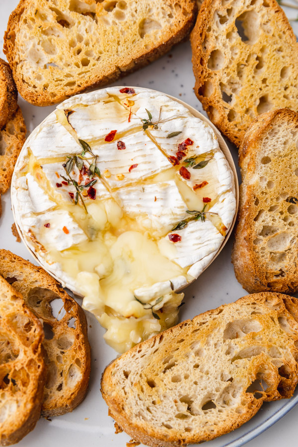 a close up on baked camembert on a plate.