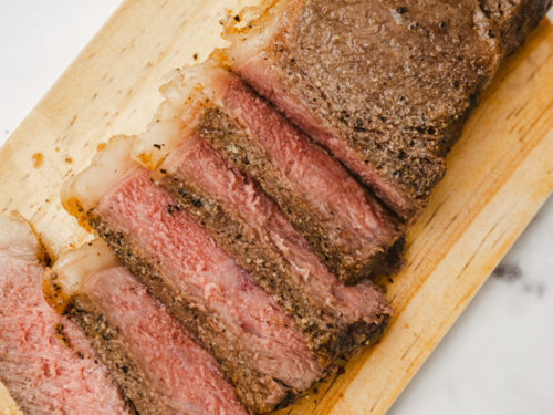 sliced steak on a board.