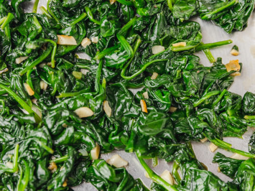 garlic sauteed spinach in a skillet.