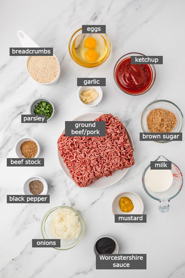 ingredients for making meatloaf on a marble surface.