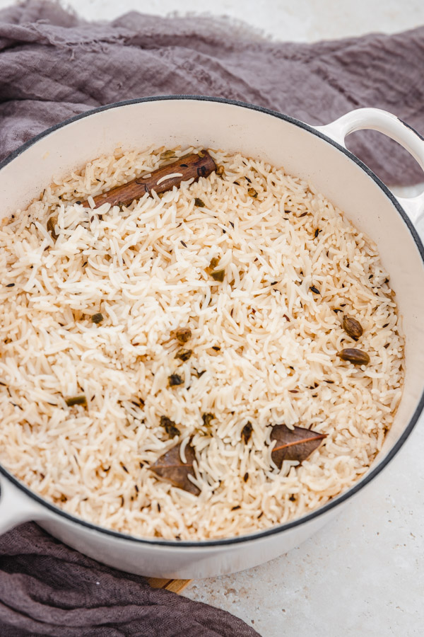 a pot of unfluffed rice placed beside a brown napkin.