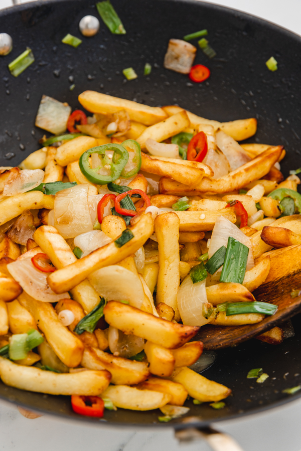 close up of salt and pepper chips in a wok.