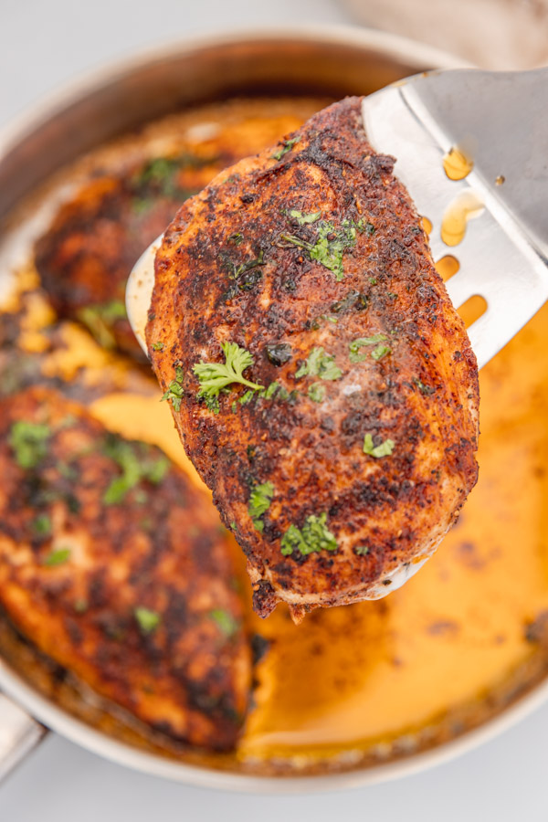 one cooked chicken breast on a fish spatula.