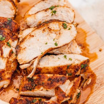 sliced juicy and tender chicken breast on a chopping board.