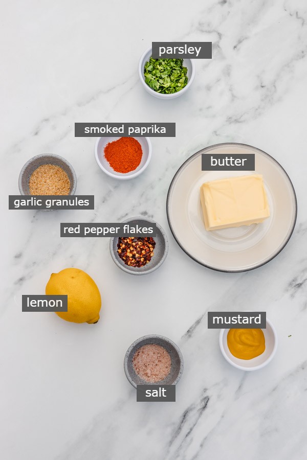 ingredients for cowboy butter placed on a marble surface.