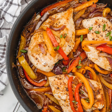 chicken breast and peppers in a skillet.