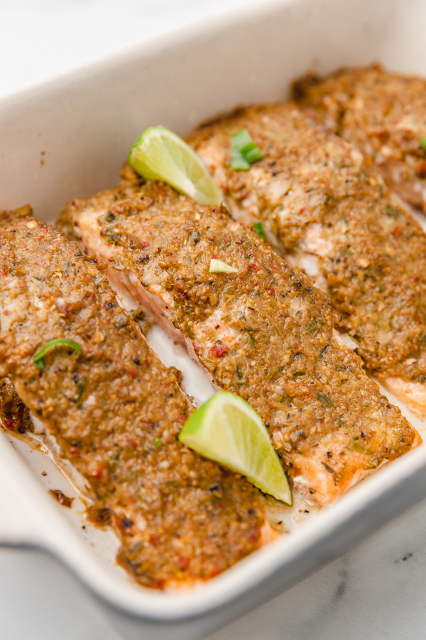 baked salmon covered in jerk seasoning in a baking dish.