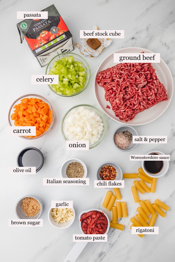 ingredients to make one pot pasta bolonese on a marble surface.