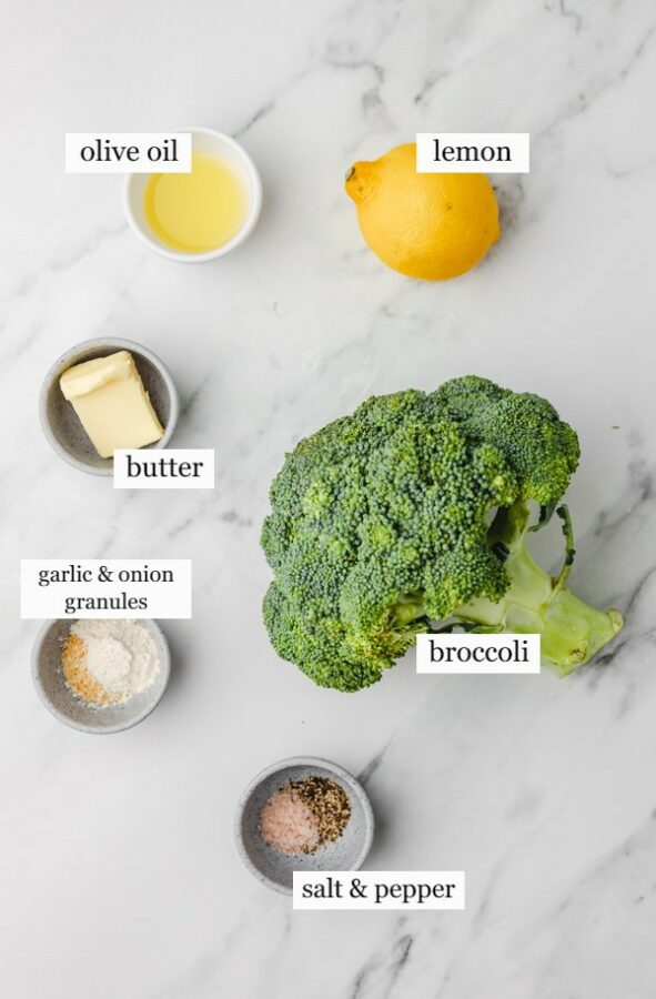 the ingredients needed to make sauteed broccoli on a marble surface.