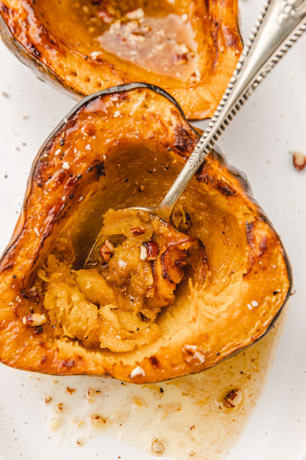 a spoon scooping cooked acorn squash.