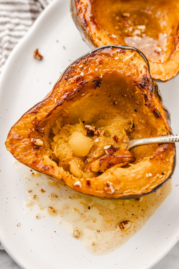 a spoon in a cooked acorn squash.