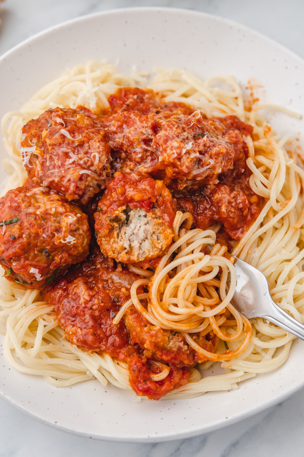 meatballs in tomato sauce served over spaghetti.