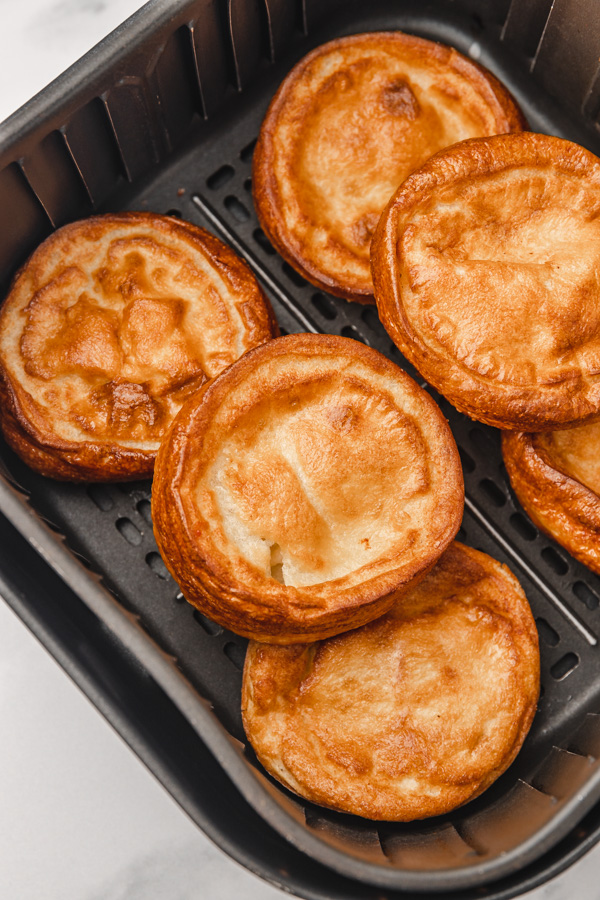 6 giant yorkshire pudding in air fryer basket.