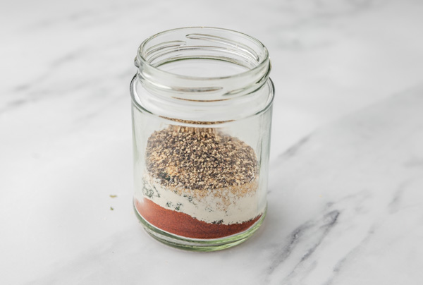 dried herbs and spices in a glass jar.