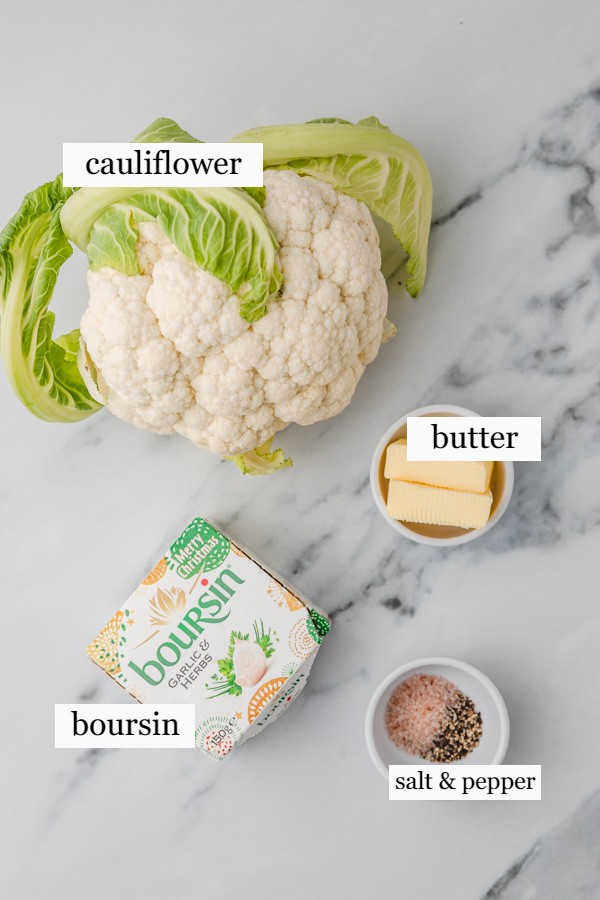 ingredients needed to make cauliflower mash laid against a marble surface.