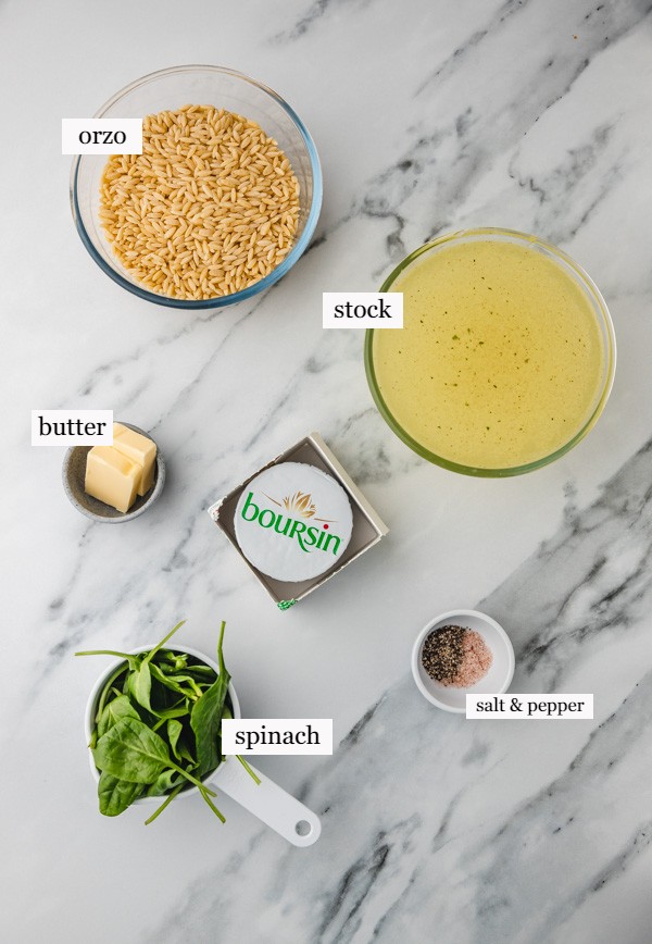 ingredients needed to make boursin orzo on a marble surface.