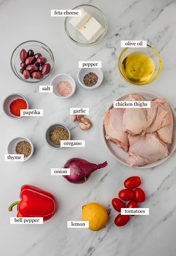 ingredients needed to make greek chicken on a marble surface.