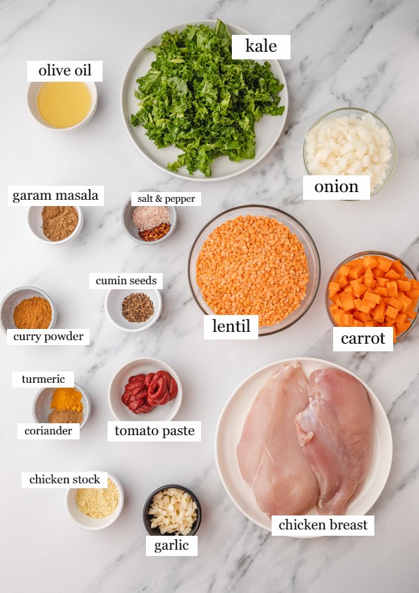 ingredients needed to make lentil chicken soup on a counter.