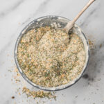 garlic herb seasoning in a bowl with a spoon.