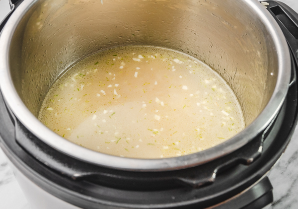 water and oil covering ras rice in instant pot.