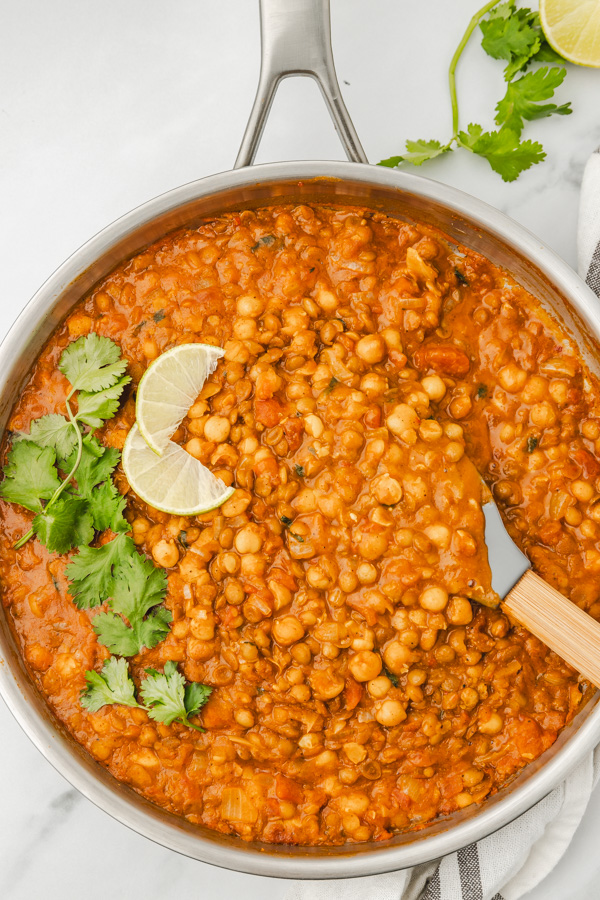 creamy chickpea and lentil curry in a skillet.