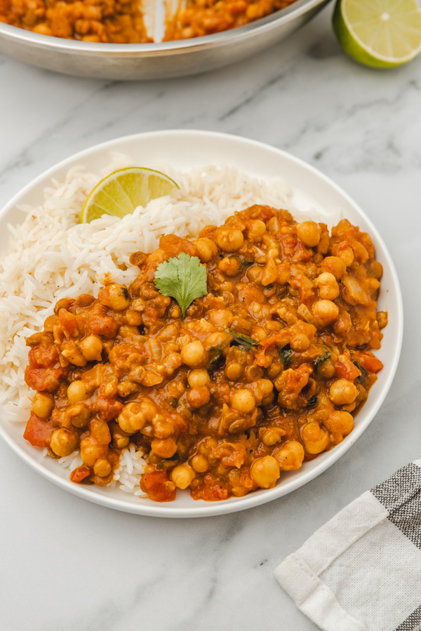 a plate of white rice and lentil and chickpea curry.