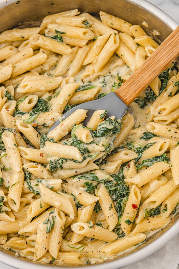 creamy spinach pasta in a skillet. 