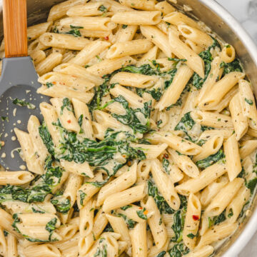 a skillet of creamy spinach pasta.