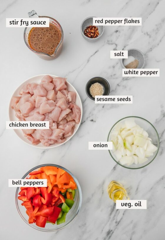 ingredients for stir fry on a white marble surface.