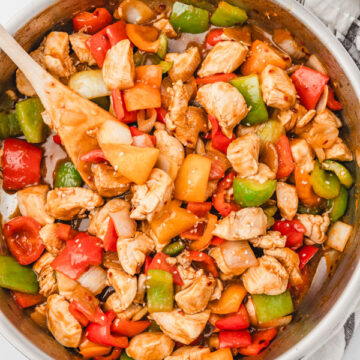 chicken and peppers in a skillets.
