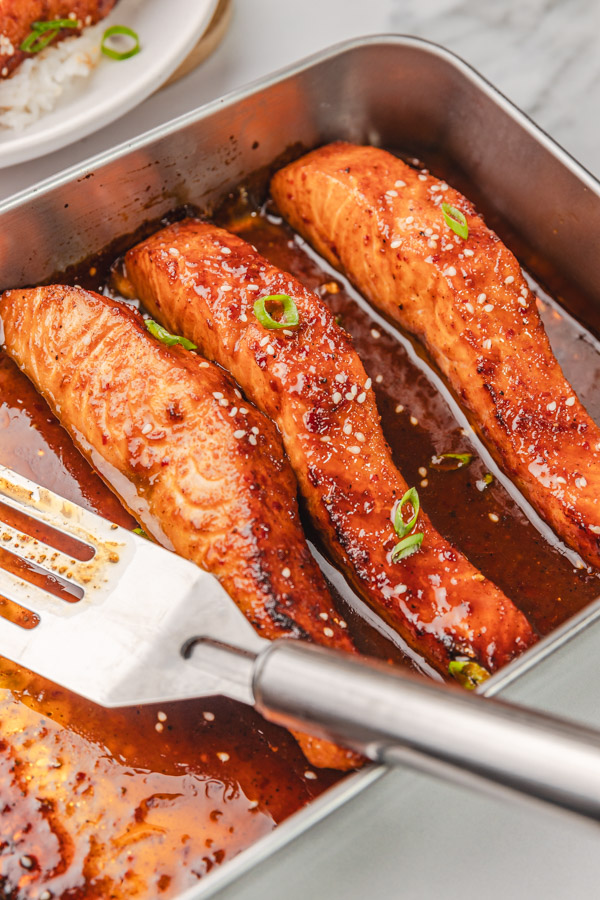 three salmon fillets in sticky sauce.