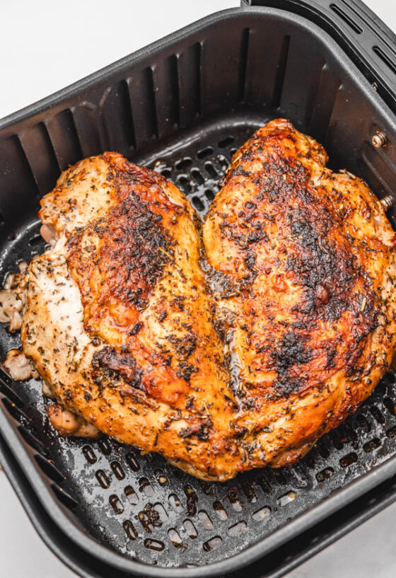butterflied boneless turkey breast in air fryer basket.