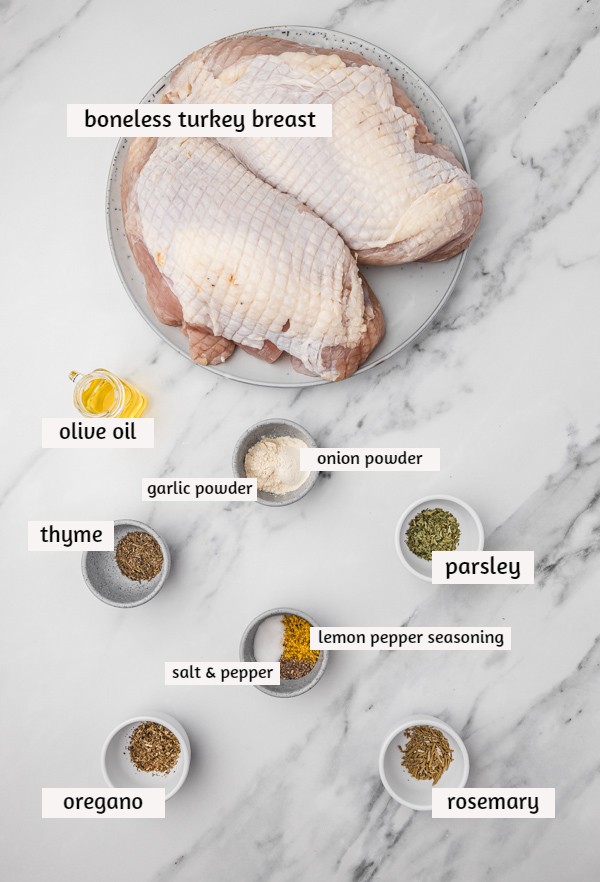 ingredient needed to cook air fryer turkey breast laid on a white marble surface.