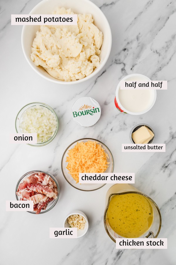 ingredients needed to make mashed potato soup placed on a white marble surface.