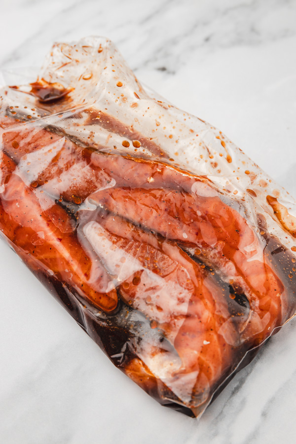 marinating salmon in a ziploc bag.