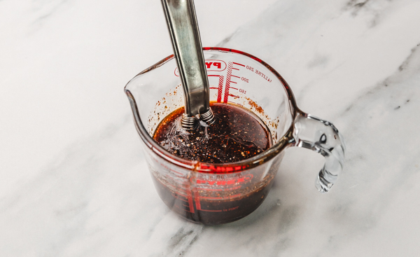 marinade with whisk in a small measuring jug.