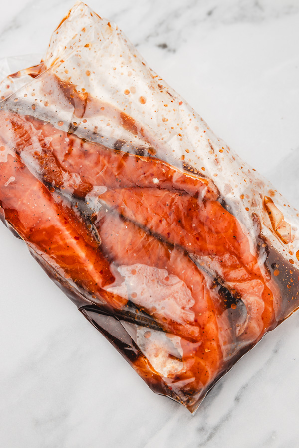 salmon fillets in marinade in a ziploc bag.