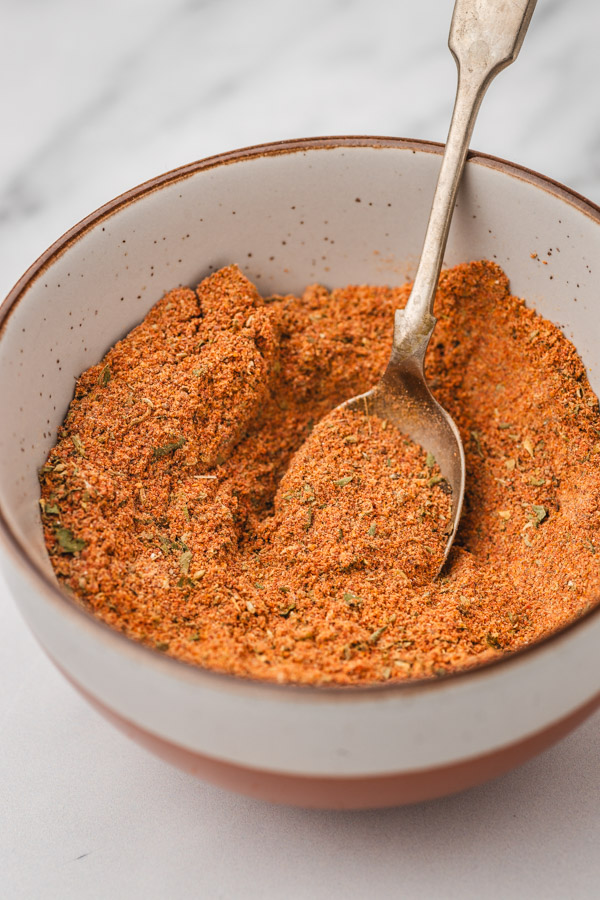 spice blend in a bowl with a spoon.