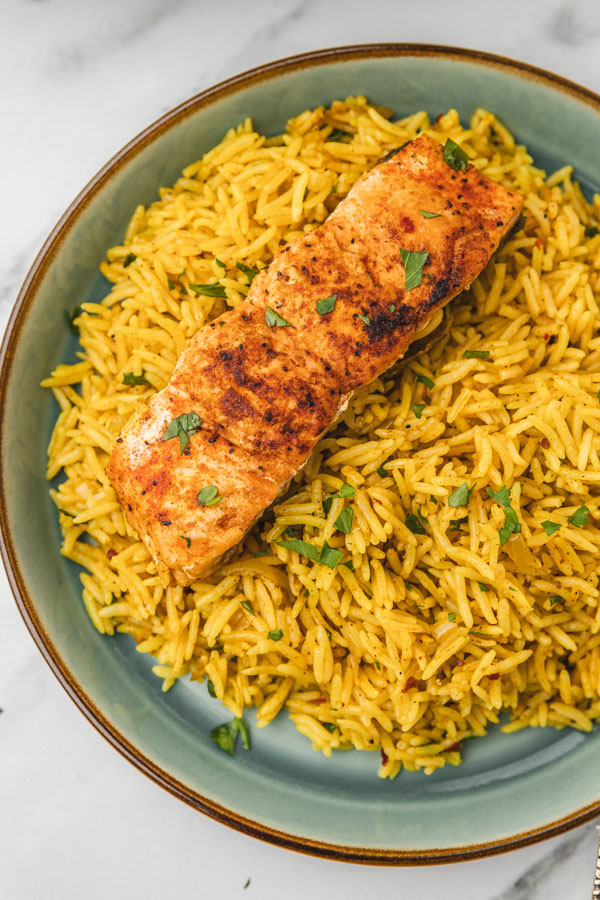 a plate of salmon and rice.