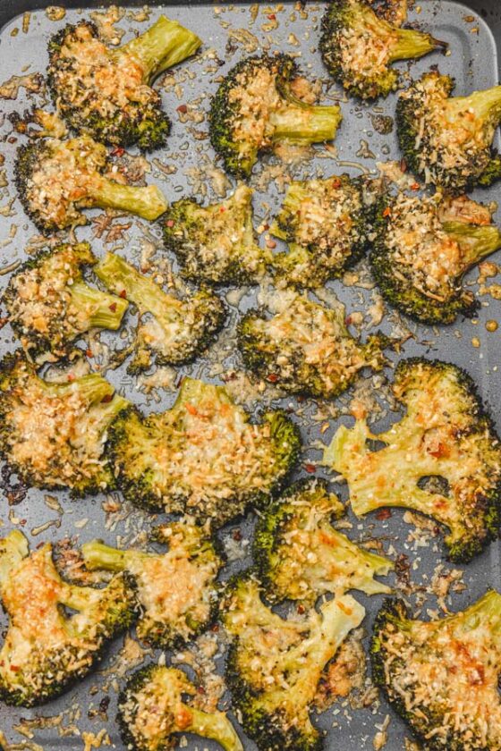 crispy smashed broccoli with parmesan cheese in a baking tray.